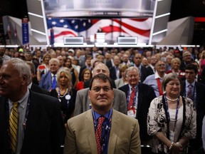 Delegates stand for the official photograph during the Republican National Convention (RNC) in Cleveland, Ohio, U.S., on Monday, July 18, 2016. The day before the start of the Republican National Convention in Cleveland, Reince Priebus said Donald Trump has to use the gathering to convince Americans he can be presidential. Photographer: John Taggart/Bloomberg ORG XMIT: 654970125