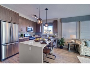 The kitchen and dining area in the Fish Creek 2 show suite at Cranston Ridge by Cardel Lifestyles.