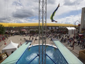 Crystal Schick/ Postmedia CALGARY, AB -- The Flying Fools High Diving Show climb to 80 feet (25 meters), and dive into a pool that is only three meters deep, for audiences at the Calgary Stampede, on July 12, 2016. --  (Crystal Schick/Postmedia) (For  story by  ) Postmedia