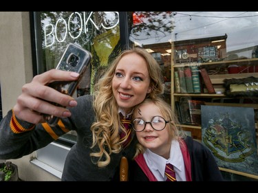 Natalia and Tatyana Mori do a selfie in front of Pages book store in Kensington renamed Flourish and Blotts in honour of the new Harry Potter book in Calgary, Ab., on Sunday July 31, 2016. They were dressed as Hogwarts students for the event. Mike Drew/Postmedia