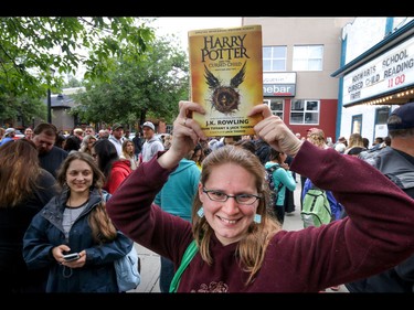 Tara Jorgensen shows off her copy of the new Harry Potter book in Calgary, Ab., on Sunday July 31, 2016. Hundreds of Potter fans thronged Kensington which was reimagined as Diagon Alley to celebrate the release of Harry Potter And The Cursed Child.  Mike Drew/Postmedia