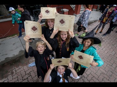 The Van Sluys and McKenna kids get set to follow their  marauder's maps just like Harry Potter in Calgary, Ab., on Sunday July 31, 2016. Hundreds of Potter fans thronged Kensington which was reimagined as Diagon Alley to celebrate the release of Harry Potter And The Cursed Child.  Mike Drew/Postmedia