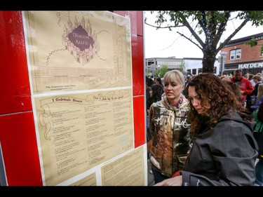 Studying the marauder's maps in the Harry Potter spirit in Calgary, Ab., on Sunday July 31, 2016. Hundreds of Potter fans thronged Kensington which was reimagined as Diagon Alley to celebrate the release of Harry Potter And The Cursed Child.  Mike Drew/Postmedia