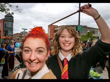 Laura McLean puts the magic touch on Taylor Brewis's Weasley-red hair in Calgary, Ab., on Sunday July 31, 2016. Hundreds of Potter fans thronged Kensington which was reimagined as Diagon Alley to celebrate the release of Harry Potter And The Cursed Child.  Mike Drew/Postmedia