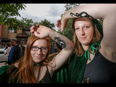 Sure, they're Death-Eaters but Karen McPeak, left, and Alex Rocca are really quite nice in Calgary, Ab., on Sunday July 31, 2016. Hundreds of Potter fans thronged Kensington which was reimagined as Diagon Alley to celebrate the release of Harry Potter And The Cursed Child.  Mike Drew/Postmedia