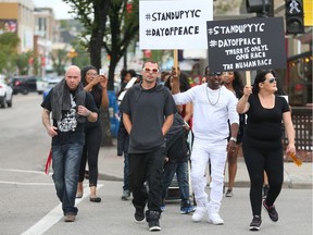 A group of about 25 supporters walk on 17 Ave SW in downtown Calgary, Alt on Sunday July 17, 2016 to bring awareness to the 'rising number of incidents involving police brutality and excessive force in Calgary and around the world. Jim Wells//Postmedia