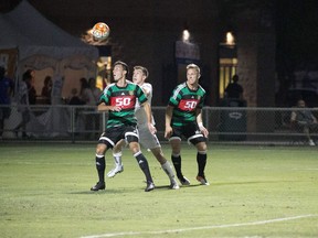 A pair of Foothills FC players challenge an FC Tucson player for the ball during Saturday's 2-1 win over the host team in Tucson, Ariz. Foothills next plays the Ocean City Nor'easters in a semifinal next weekend. (Michael Benson)