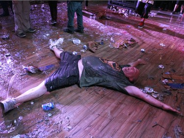 An Insane Clown Posse fan bathes in the aftermath of the concert after the band finished their set at the Marquee Beer Market in Calgary, Alta. on Tuesday July 12, 2016.