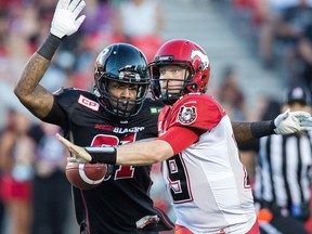 Aston Whiteside prepares to tackle Bo Levi Mitchell as the Ottawa Redblacks take on the Calgary Stampeders in CFL action at TD Place in Ottawa. Assignment - 121186 Photo taken at 19:58 on July 24. (Wayne Cuddington / Ottawa Citizen)