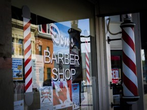 Don's Barber Shop has been a fixture in Fort MacLeod, Alberta, for over fifty years and the shop has been a barber's for nearly 100 years. The front window reflects the town in Fort Macleod, Alta., Friday, June 24, 2016. THE CANADIAN PRESS/Jeff McIntosh ORG XMIT: JMC301