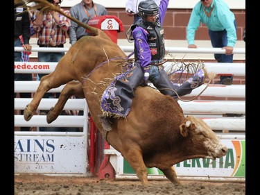 Chandler Bownds from Lubbock Texas rode Sugar Smack to a first place tie of 87.5 during the Bull Riding event at the Calgary Stampede Rodeo, Sunday July 10, 2016.