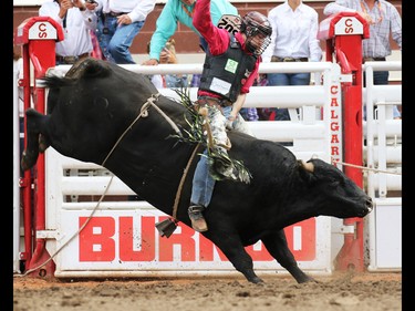 Dakota Butter from Kindersley Saskatchewan rode Preacher to a first place tie of 87.5 during the Bull Riding event at the Calgary Stampede Rodeo, Sunday July 10, 2016.