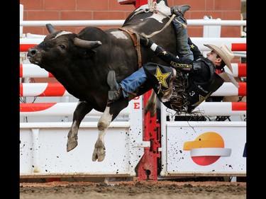 Joao Ricardo Vieira from Sao Paulo Brazil flies off Tricky Deal in the bull riding on day 3 of the Calgary Stampede Rodeo, Sunday July 10, 2016.