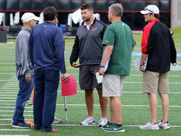 Six NFL scouts talk at McMahon Stadium in Calgary on Monday July 11, 2016 while testing University of Calgary Dinos wide receiver Rashaun Simonise. Simonise has been declared eligible for the NFL supplementary draft.