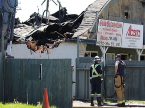 Firefighters and fire investigators remain on the scene of an overnight industrial fire which appeared to destroy an automotive repair business at 4232 16A Street on Ogden in Calgary on Sunday, July 24, 2016.