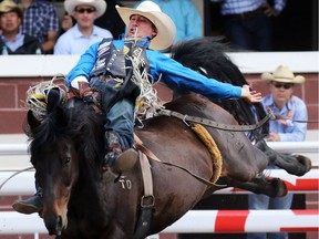 Jake Vold from Airdrie, Alberta took the top spot in the Bareback event riding Whiskey Bent on Day 3 of the Calgary Stampede Rodeo, Sunday July 10, 2016. Gavin Young/Postmedia