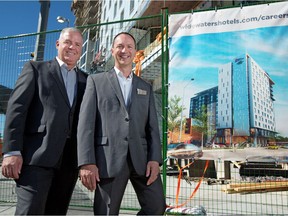 Mark Nichols, director of sales and marketing, left and Chris Vachon, general manager, stand near the construction site for the Hilton Garden Inn and Homewood Suites on Thursday July 21, 2016. The new hotel will open in Calgary's East Village this fall.