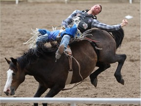 Orin Larson from Inglis, Manitoba rides Gypsey Soul in the Bareback event at the Calgary Stampede Rodeo on Wednesday July 13, 2016.