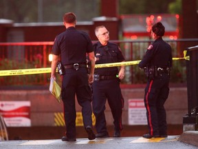 Calgary Police are shown at the scene of a police-involved shooting that left a man dead the night before in Inglewood in southeast Calgary, Alta on Friday July 15, 2016.