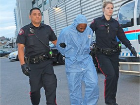 Police escort Edward Downey into the Court Services Section in downtown Calgary on Thursday July 14, 2016 after he was arrested in the murders of Taliyah Leigh Marsman and her mother Sarah Baillie.