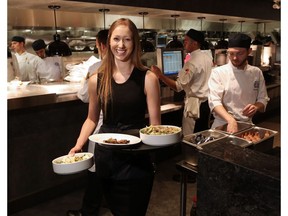 Servers work during the busy lunch hour at the Earls.67 restaurant in downtown Calgary on Monday July 11, 2016.