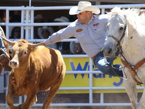 Seth Brockman from Wheatland Wyoming took top money in the Steer Wrestling event on Day 3 of the Calgary Stampede Rodeo, Sunday July 10, 2016. Gavin Young/Postmedia