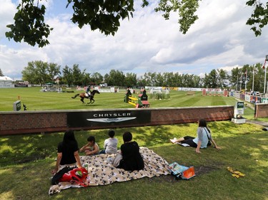 Spectators watch riders in the All Canada ring during the Spruce Meadows North American.