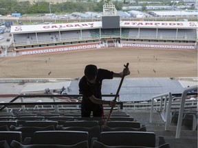Jason Bauert, Calgary Stampede employee, clean the grandstands between shows on day six of Calgary Stampede on July 13, 2016.