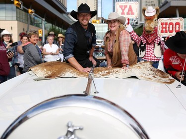 2016 Calgary Stampede Parade marshals Jann Arden and Paul Brandt wave to the crowd during the parade in Calgary,