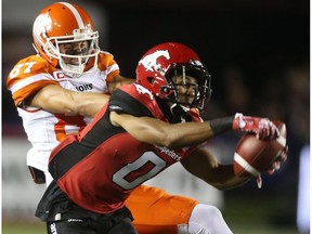 Calgary Stampeders Ciante Evans, right, intercepts a pass to BC Lions Marco Iannuzzi during CFL action at McMahon Stadium in Calgary on July 29, 2016.