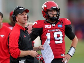 Calgary Stampeders head coach Dave Dickenson, left and QB Bo Levi Mitchell during their game against the Winnipeg Blue Bombers in CFL action at McMahon Stadium in Calgary, Alta.. on Friday July 1, 2016. Leah hennel/Postmedia