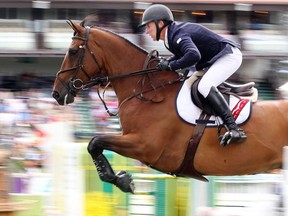 Jonathan McCrea of the USA rides Special Lux in the Spruce Meadows Classic, the final event of  the North American Sunday July 10, 2016. (Ted Rhodes/Postmedia)