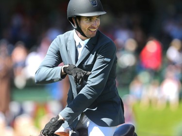 Calgary's Chris Surbey smiles as he rides past the playpen after riding Quetchup de la Roque to victory in the Enbridge Classic Derby   during the North American at Spruce Meadows Sunday July 10, 2016.