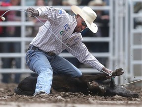 Cory Solomon of Prairie View, Texas takes first place on the day in Tie-Down Roping at the Calgary Stampede Rodeo Thursday July 14, 2016. (Ted Rhodes/Postmedia)