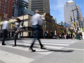 Pedestrians walk in downtown Calgary during lunch hour. (file photo) GAVIN YOUNG/POSTMEDIA