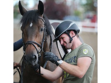 German rider Philipp Weishaupt prepares his horse to ride in the sand ring Tuesday July 5, 2016 prior to the Wednesday start of the Spruce Meadows North American.