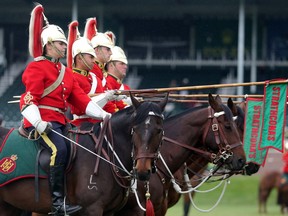 Lieutenant Erica Young of the Lord Strathcona Royal Canadians and her horse Shogun head up the honour guard during the awards ceremonies for the Encana U25 Cup at Spruce Meadows Friday June 10, 2016 on day three of The National. In addition to leading the military honour guard that performs at Spruce and takes part in all the awards ceremonies she is a Panzer tank commander. (Ted Rhodes/Postmedia)