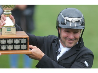 Eric Lamaze lists the ATCO Energy trophy after winning the ATCO Energy competition at the Spruce Meadows North American Wednesday afternoon July 6, 2016.