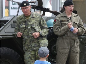 Luka Vranjes, age 3, listens as Warrant Officer Peter Jones chats with passersby at the display hosted by the Lord Strathcona's Horse Royal Canadians Historical Vehicle Troop at Spruce Meadows during the North American Friday July 8, 2016.