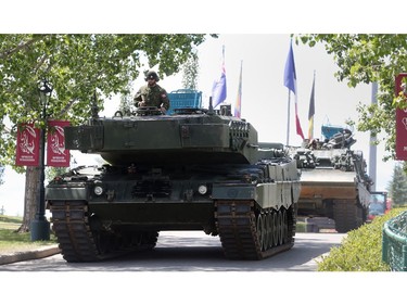 A Leopard 2A4 tank, followed by a Leopard ARF armoured recovery vehicle, make their way into Spruce Meadows for the North American following the Calgary Stampede Parade Friday July 8, 2016.