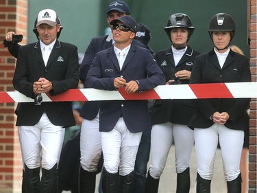 Riders heading into round two of the ATCO Queen Elizabeth Cup wait their chance to walk the course Saturday July 9, 2106 during the North American at Spruce Meadows. Eventual winner, American Kent Farrington, second from left, hangs with three Canadians, from left, Eric Lamaze, Tiffany Foster and Elizabeth Gingras.