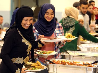 Syrians line up for the meal during the iftar, the breaking of the fast, as refugees celebrate their first Ramadan in Calgary Tuesday evening June 28, 2016 at Marlborough Community Association.