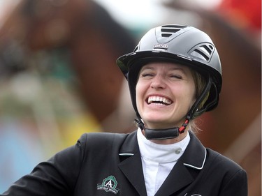 Canadian Tiffany Foster is all smiles as she accepts the Imperial trophy after winning on her horse Brighton Saturday July 9, 2016 during the Spruce Meadows North American.