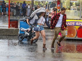 The rain pours down - temporarily - at the Calgary Stampede on Saturday July 9, 2016.