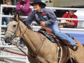 Mary Burger and Mo hit the infield on their way to yet another win in the barrel racing competition at the Calgary Stampede on Monday July 11, 2016. Mike Drew/Postmedia