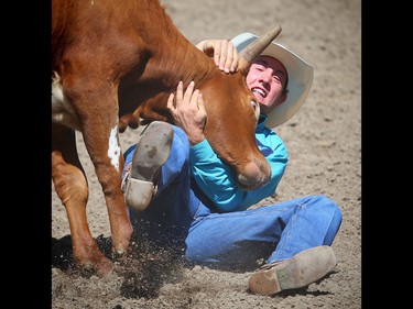 Consort, Alberta bulldogger Scott Guenthner during the steer wrestling event at the Calgary Stampede rodeo on Sunday, July 10, 2016.