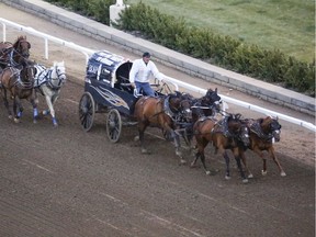 Gary Gorst tries to hold on to his lead as Jason Glass pulls up fast behind him in the Calgary Stampede's GMC Rangeland Derby.