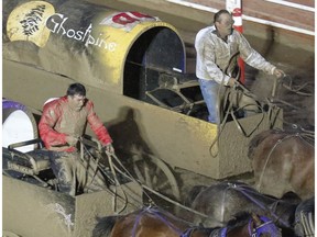 Vern Nolin, left, and Kirk Sutherland are neck and neck on the muddy track in heat nine on day eight of Calgary Stampede's GMC Rangeland Derby, on July 15, 2016. Nolin won the heat by tenth of a second.