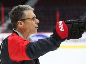 Coach Dave Cameron of the Ottawa Senators directs his team during morning practice at Canadian Tire Centre in Ottawa, April 06, 2016.   Photo by Jean Levac