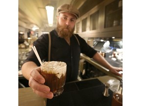 Bartender Conrad Meers poses with a great Stampede beer cocktail called the Campfire Shaft at the Last Best Brewing in Calgary, Alta on Tuesday June 21, 2016. Jim Wells//Postmedia